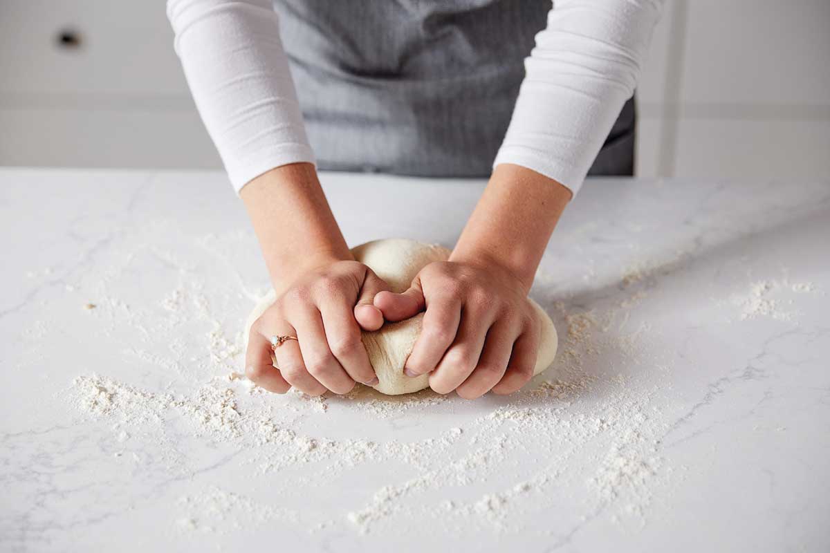 Hands kneading dough